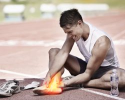 Shot of a young athlete holding his leg in pain